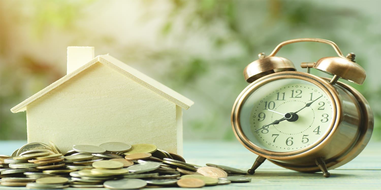 Clock and house to represent right time to sell